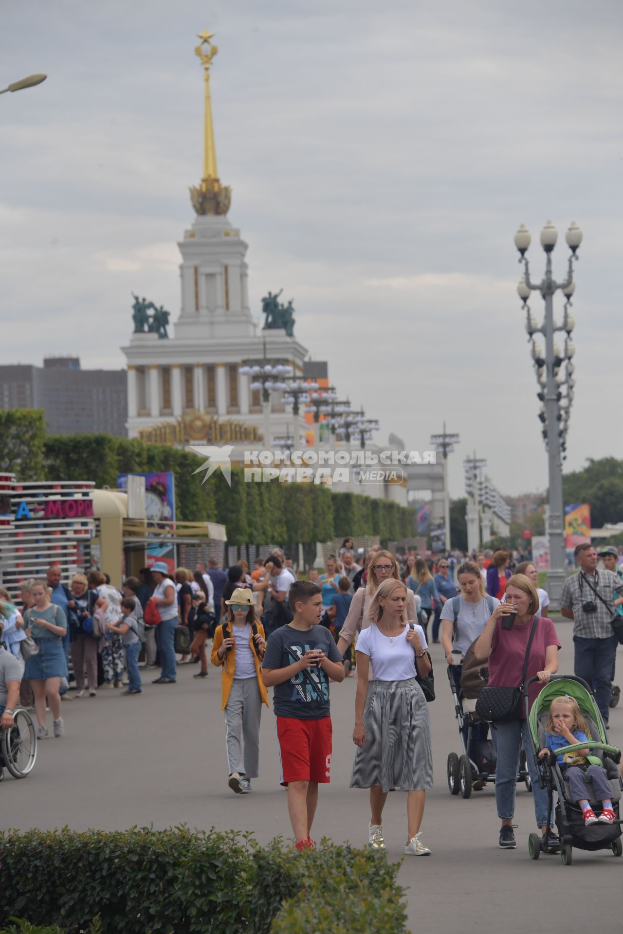 Москва.  Посетители ВДНХ на центральной аллее.