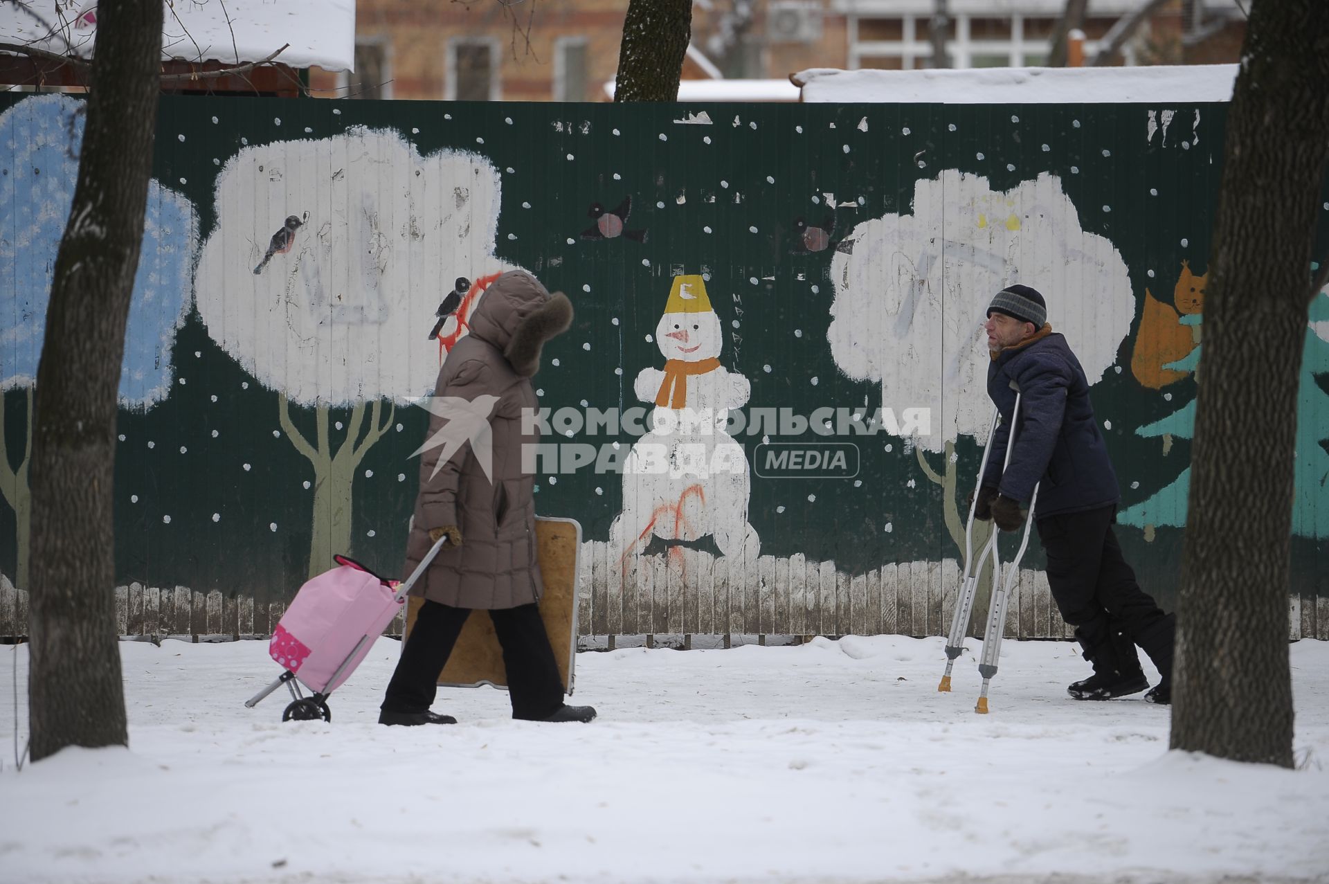 Екатеринбург. Горожане на фоне забора с нарисованым снеговиком