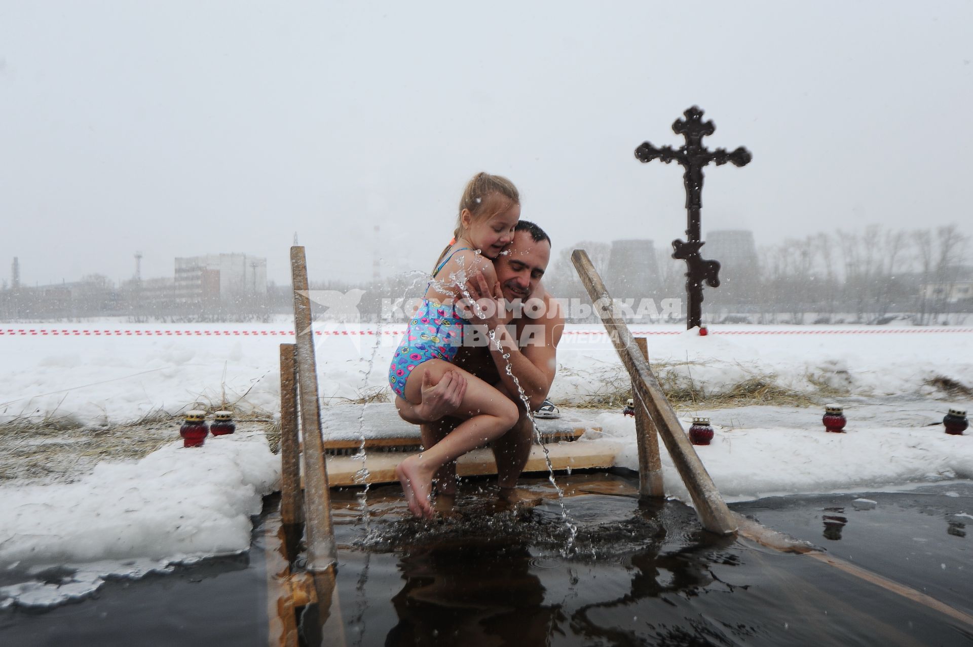 Екатеринбург. Мужчина с девочкой окунается в проруби во время крещенских купаний на Верх-Исетском пруду при температуре -3 градуса