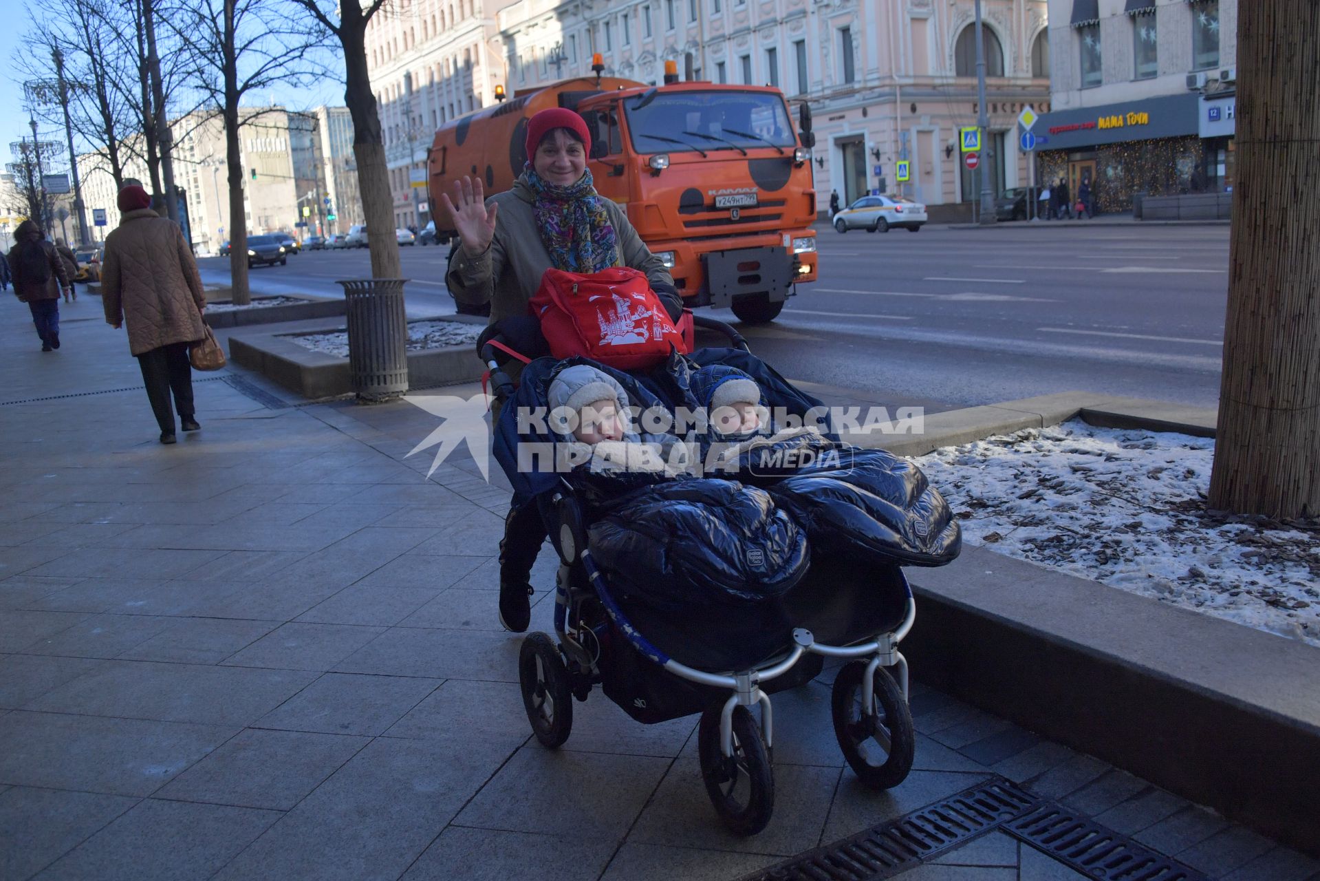 Москва. Женщина везет в коляске двойняшек  по Тверской улице.