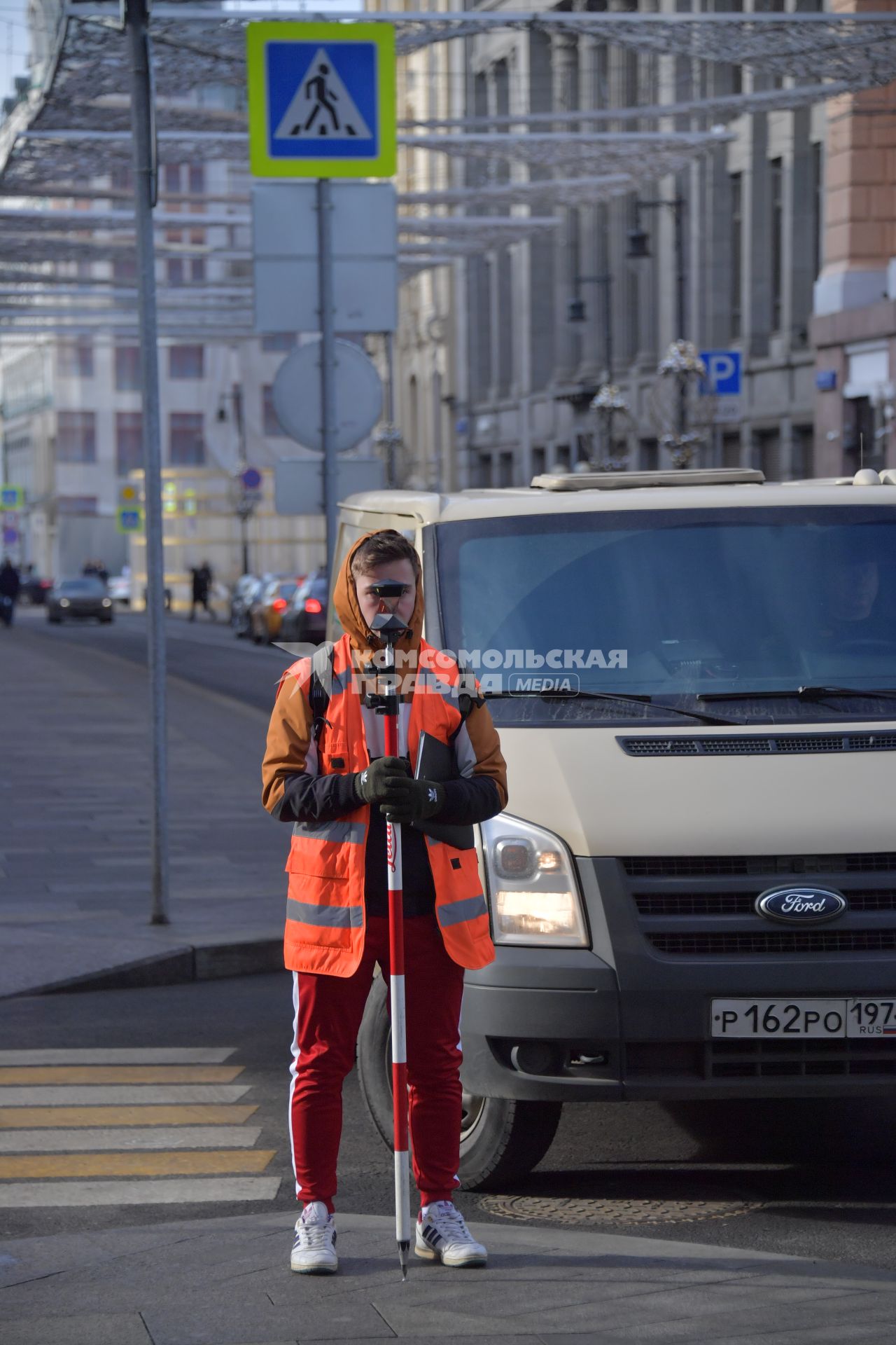 Москва. Геодезист на улице города.