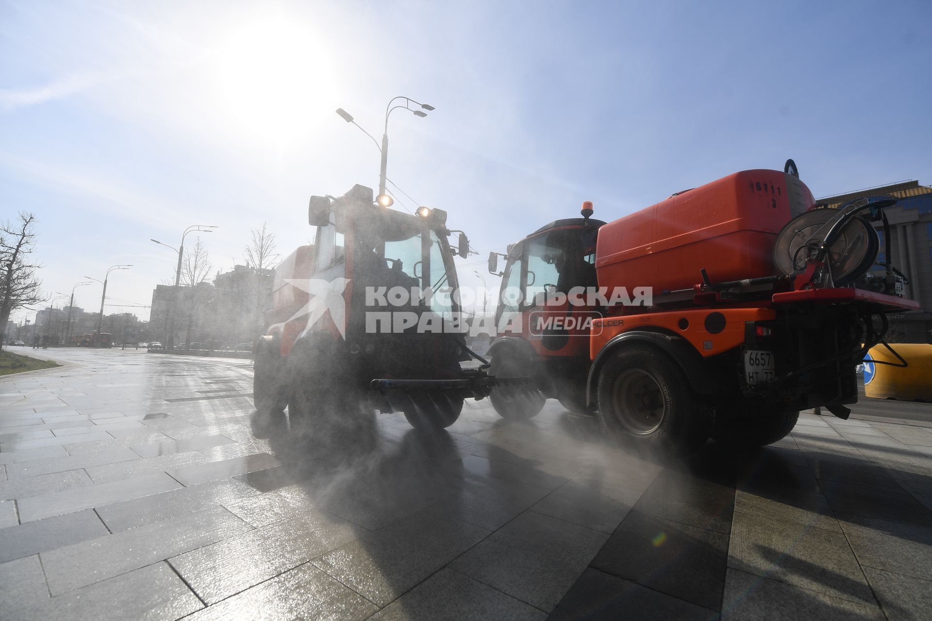 Москва.  Автомобили коммунальной службы моют улицу.