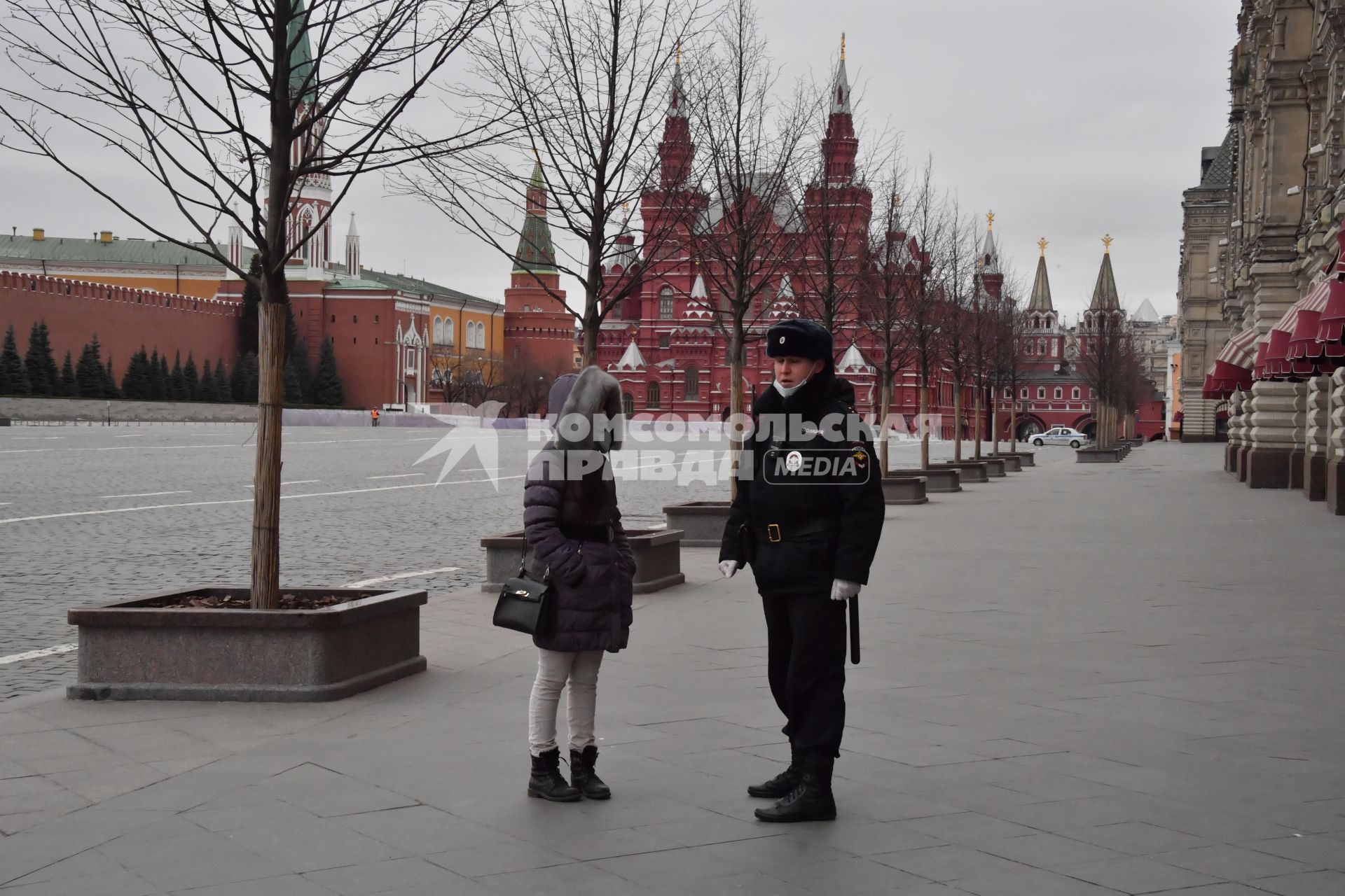 Москва.   Полицейский на Красной площади разговаривает с женщиной.