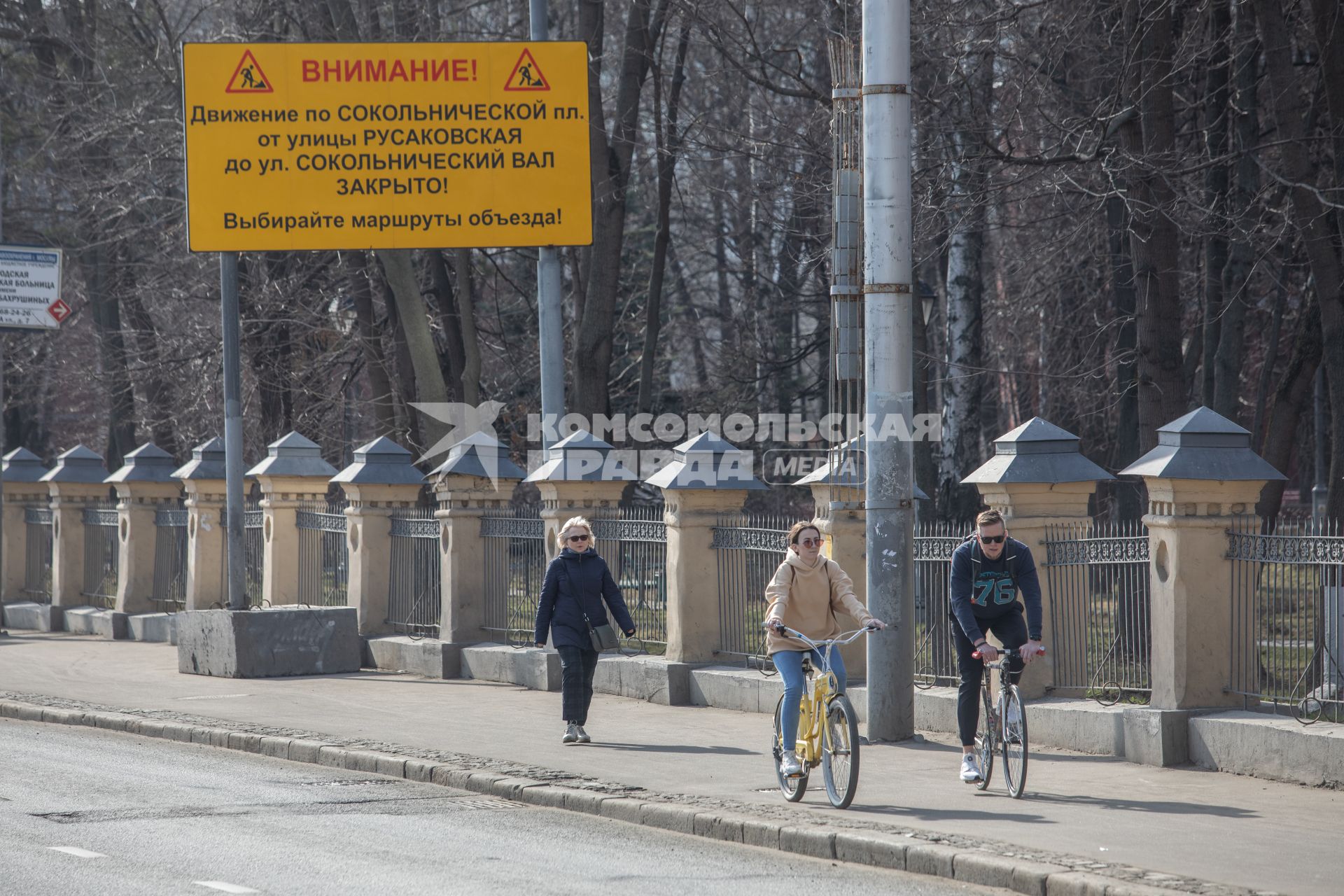 Москва.  Мужчина и женщина едут на велосипедах.