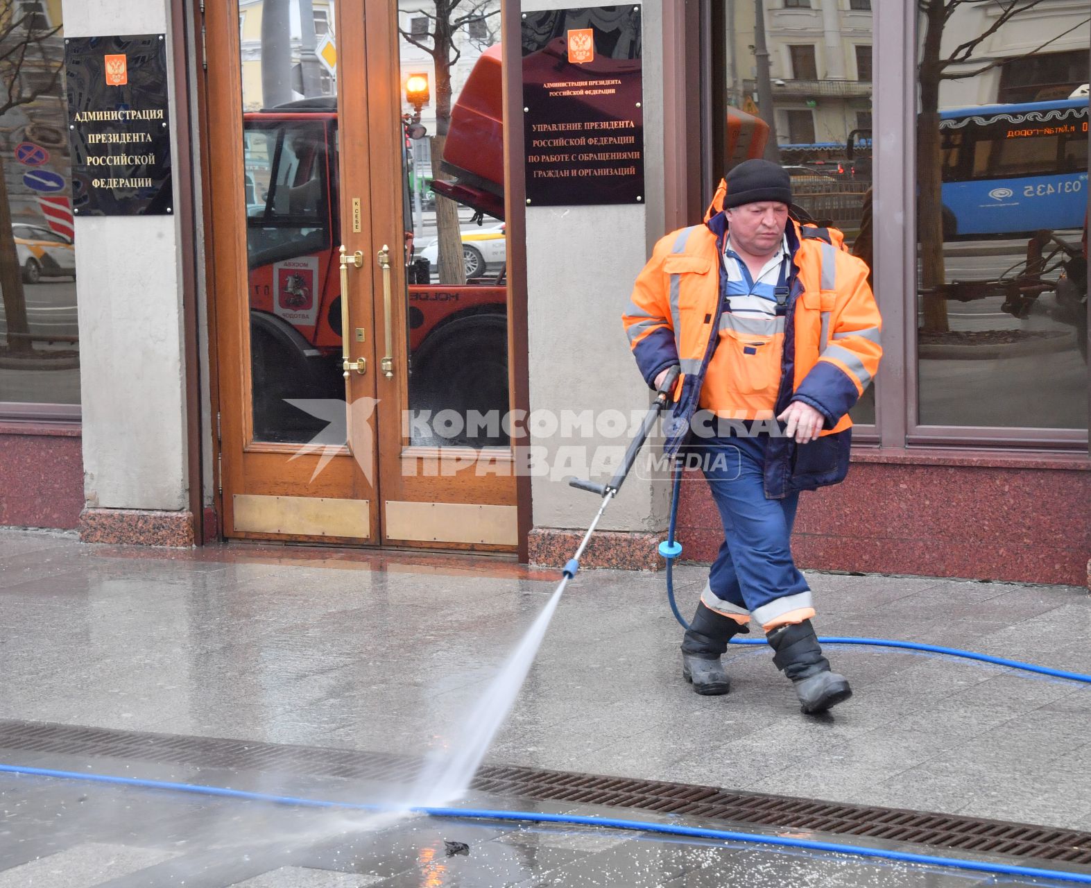 Москва. Сотрудник коммунальных служб моет тротуар.