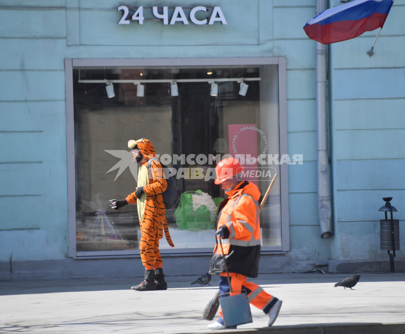 Москва. Сотрудница коммунальных служб убирает улицу.