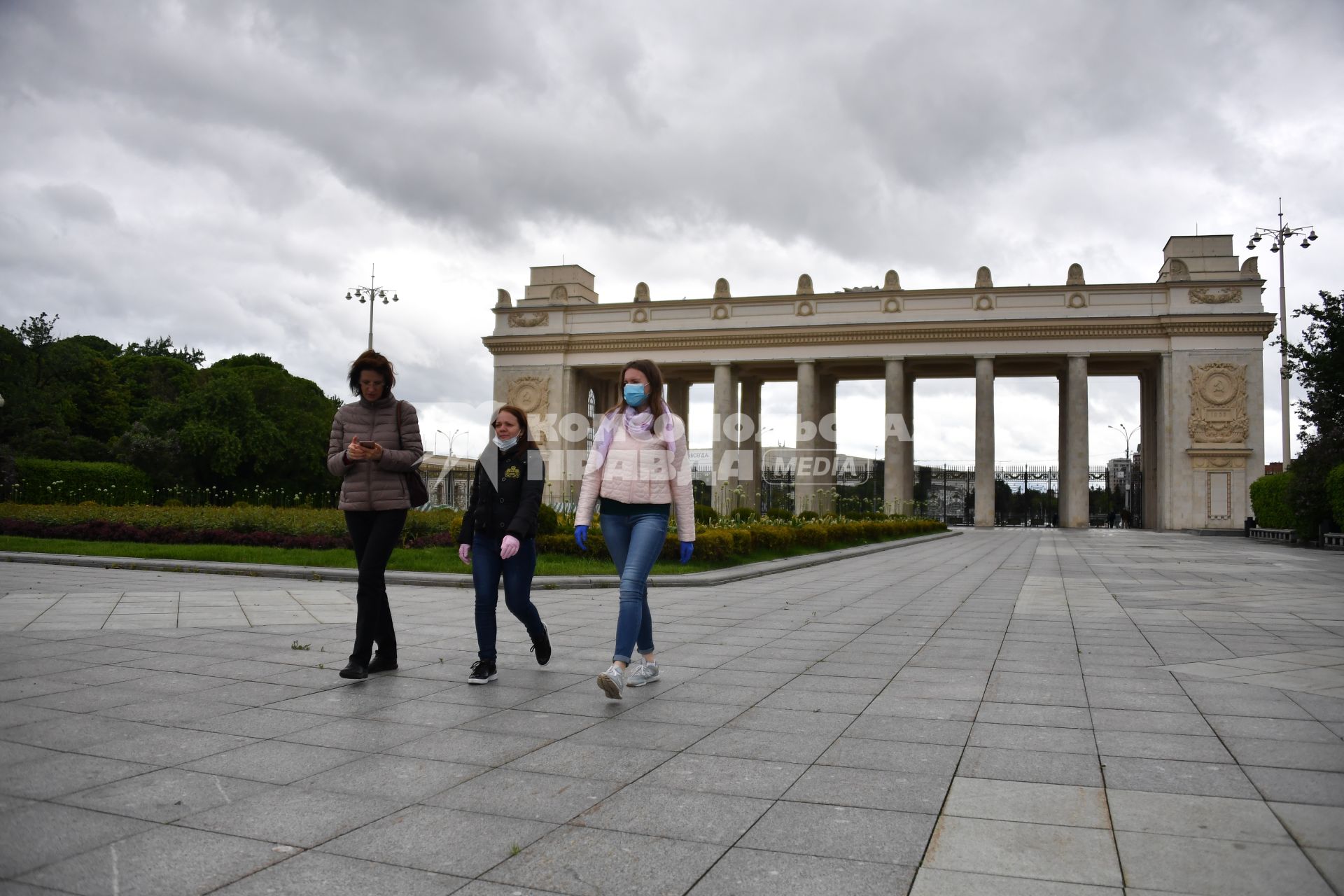 Москва.  Девушки в медицинских масках  у входа в Парк Горького, который  открылся для посещений в рамках второго этапа снятия ограничений, введенных для предотвращения распространения коронавируса.