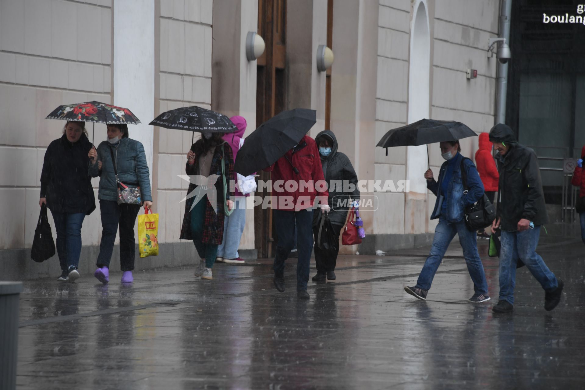 Москва.  Прохожие под дождем у метро Парк Культуры.