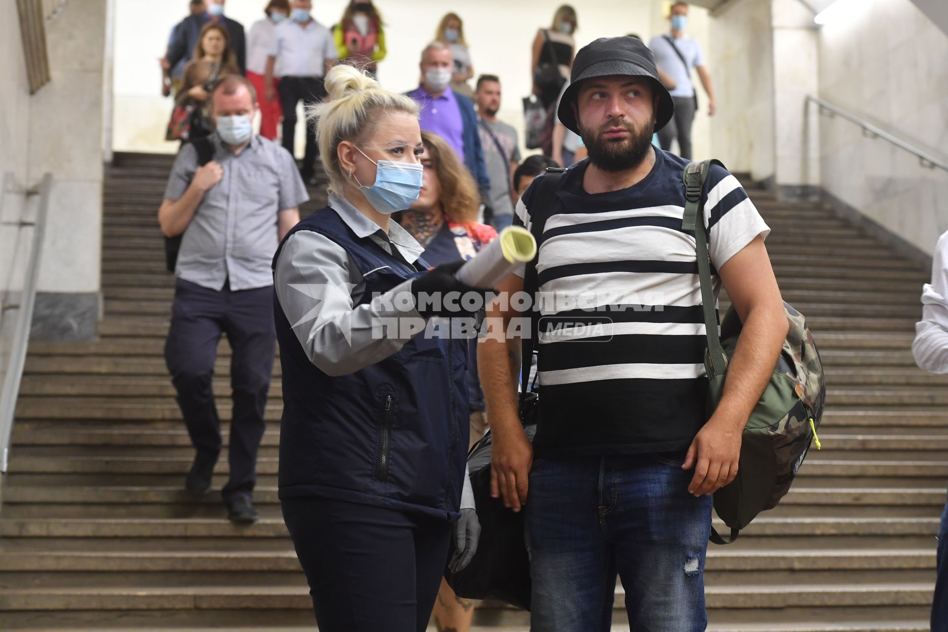 Москва. Сотрудник метрополитена просит пассажира одеть медицинскую маску.