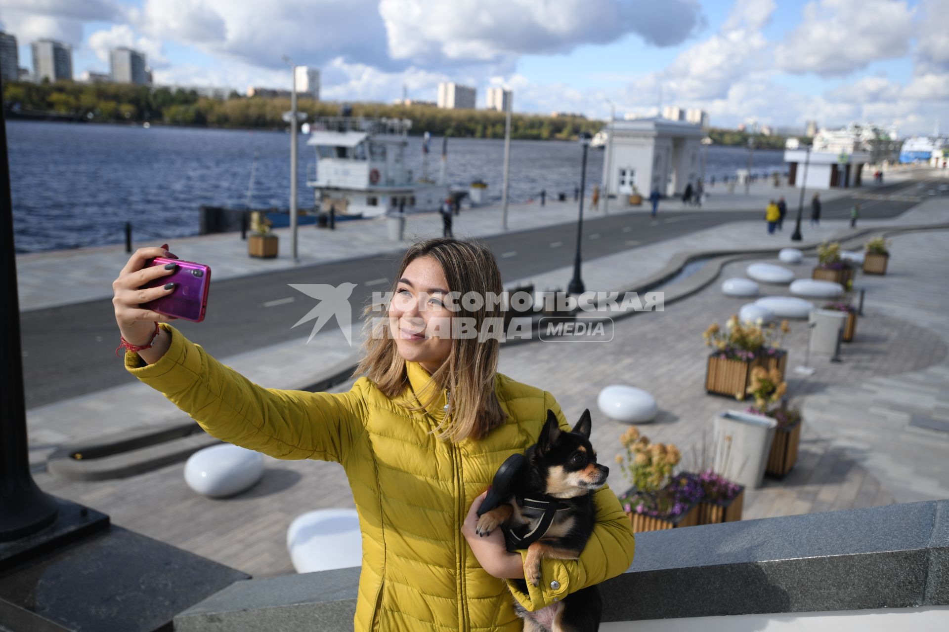 Москва. Девушка с собачкой фотографируются на набережной Северного Речного вокзала.