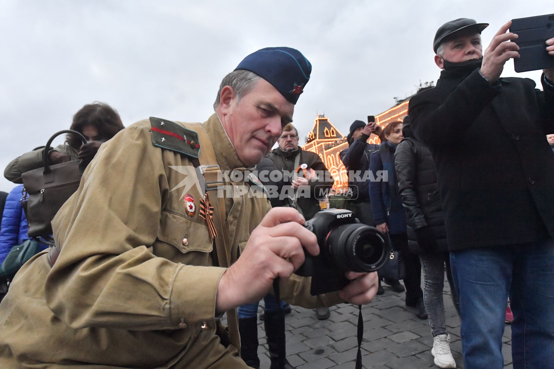 Москва. Мужчин в военной форме времен ВОВ фотографирует на  Красной площади  в День народного единства.