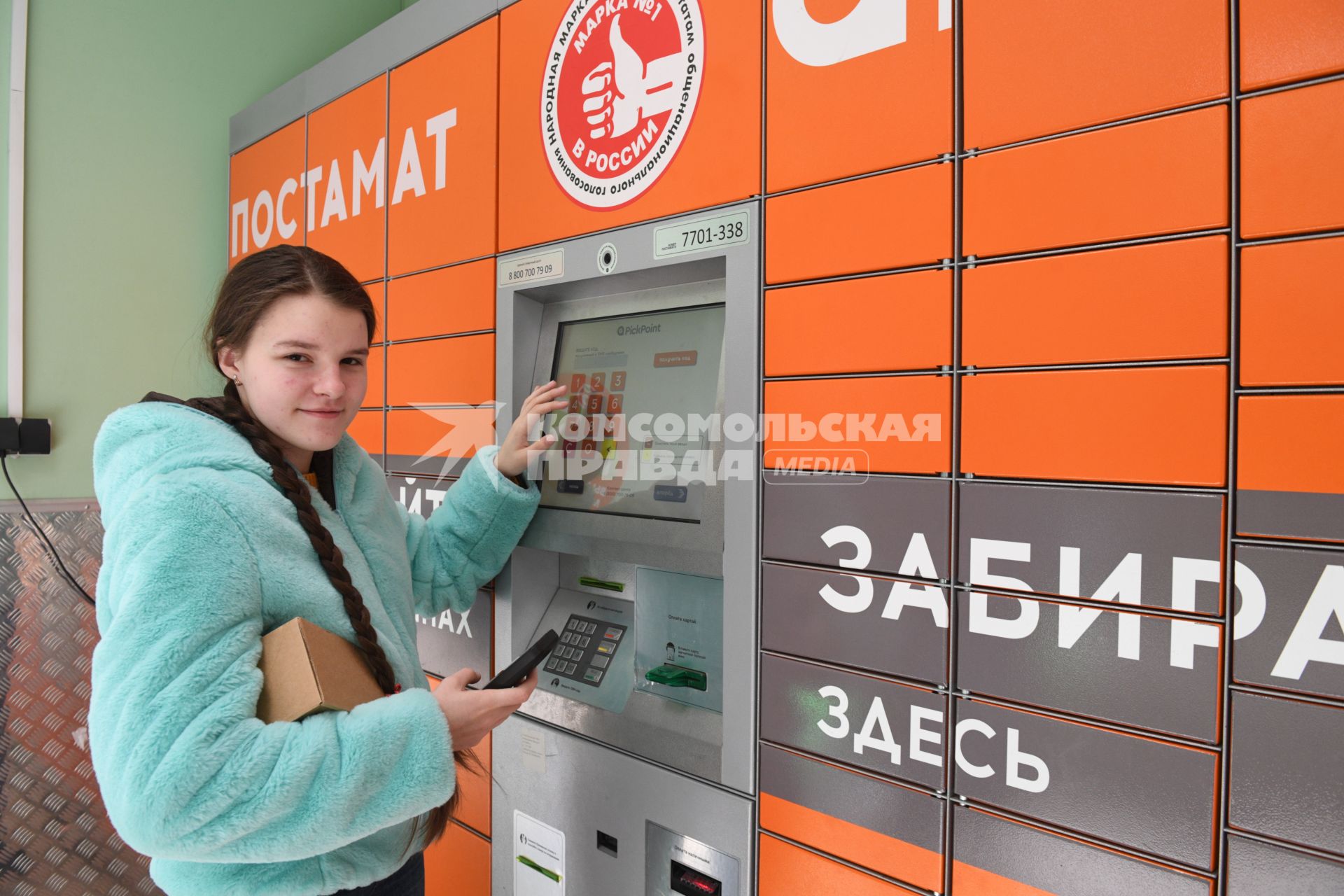 Москва. Девушка получает  заказа через постамат PickPoint.