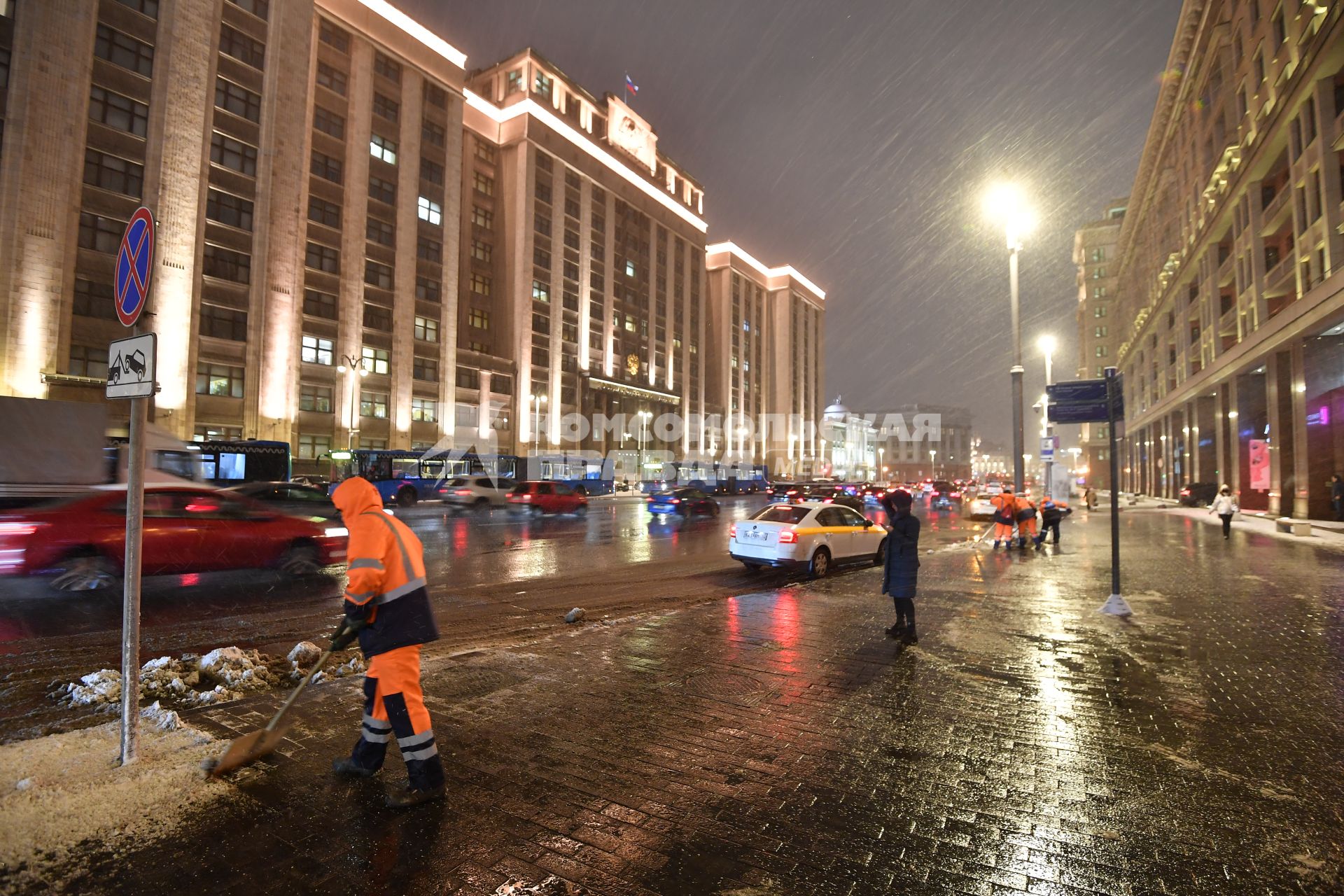 Москва. Дворник чистит снег на улице Охотный ряд.