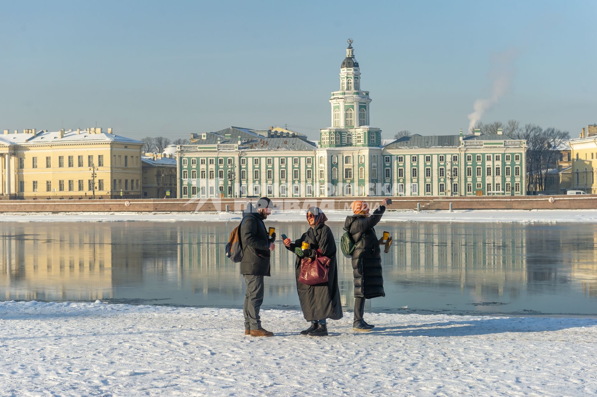 Санкт-Петербург. Прохожие фотографируются на Английской набережной.