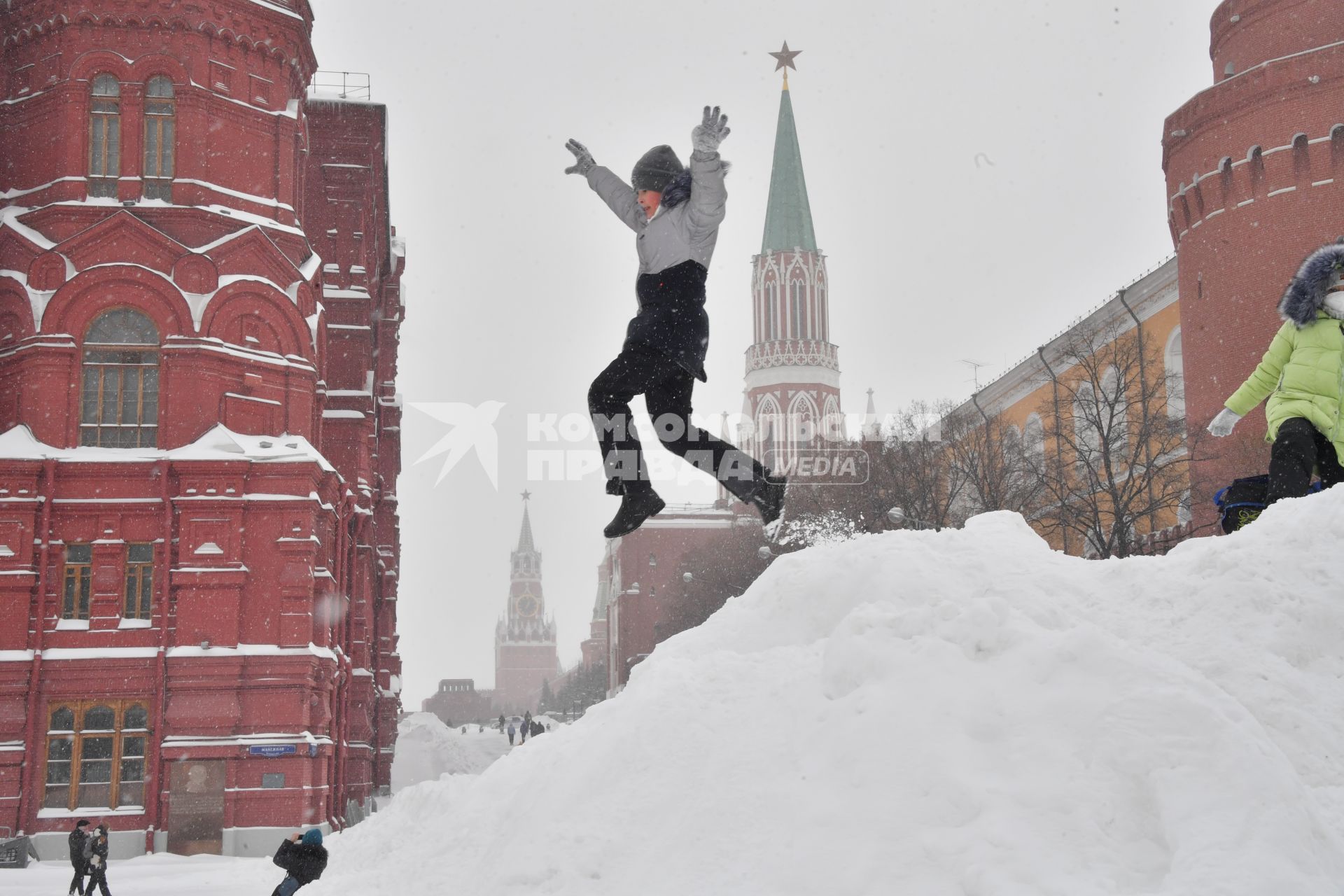 Москва. Дети играют на снежной горке на Манежной площади.