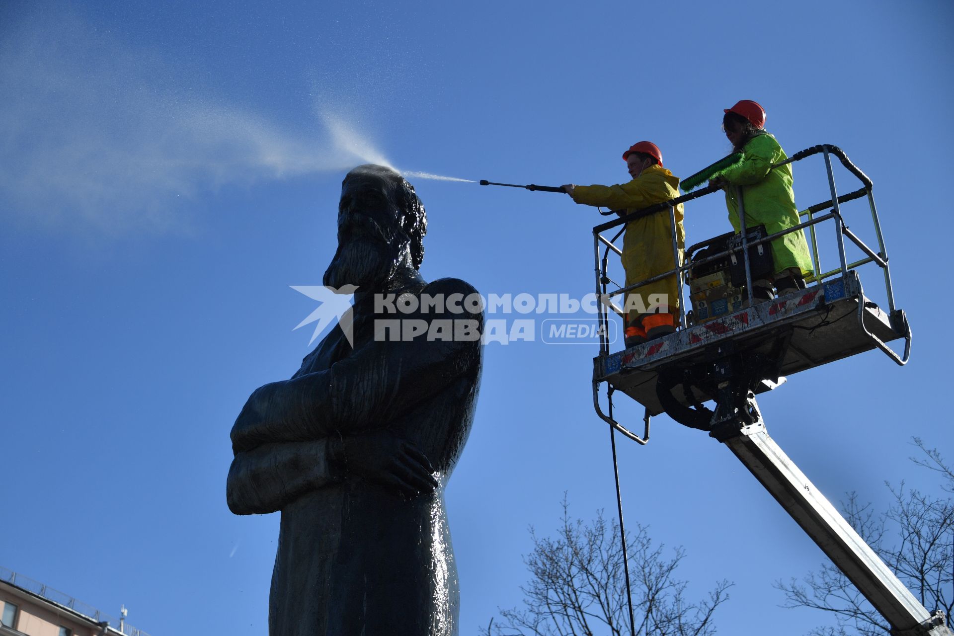 Москва. Работники коммунальных служб моют памятник Фридриху Энгесу.