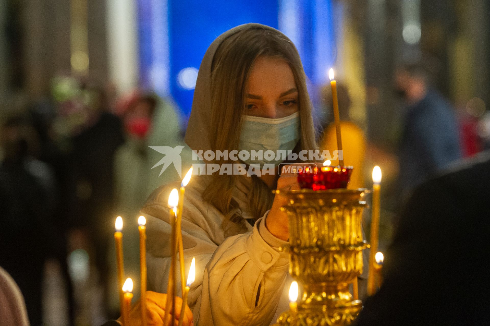 Санкт-Петербург. Девушка ставит свечку в Казанском кафедральном соборе во время Пасхального богослужения.