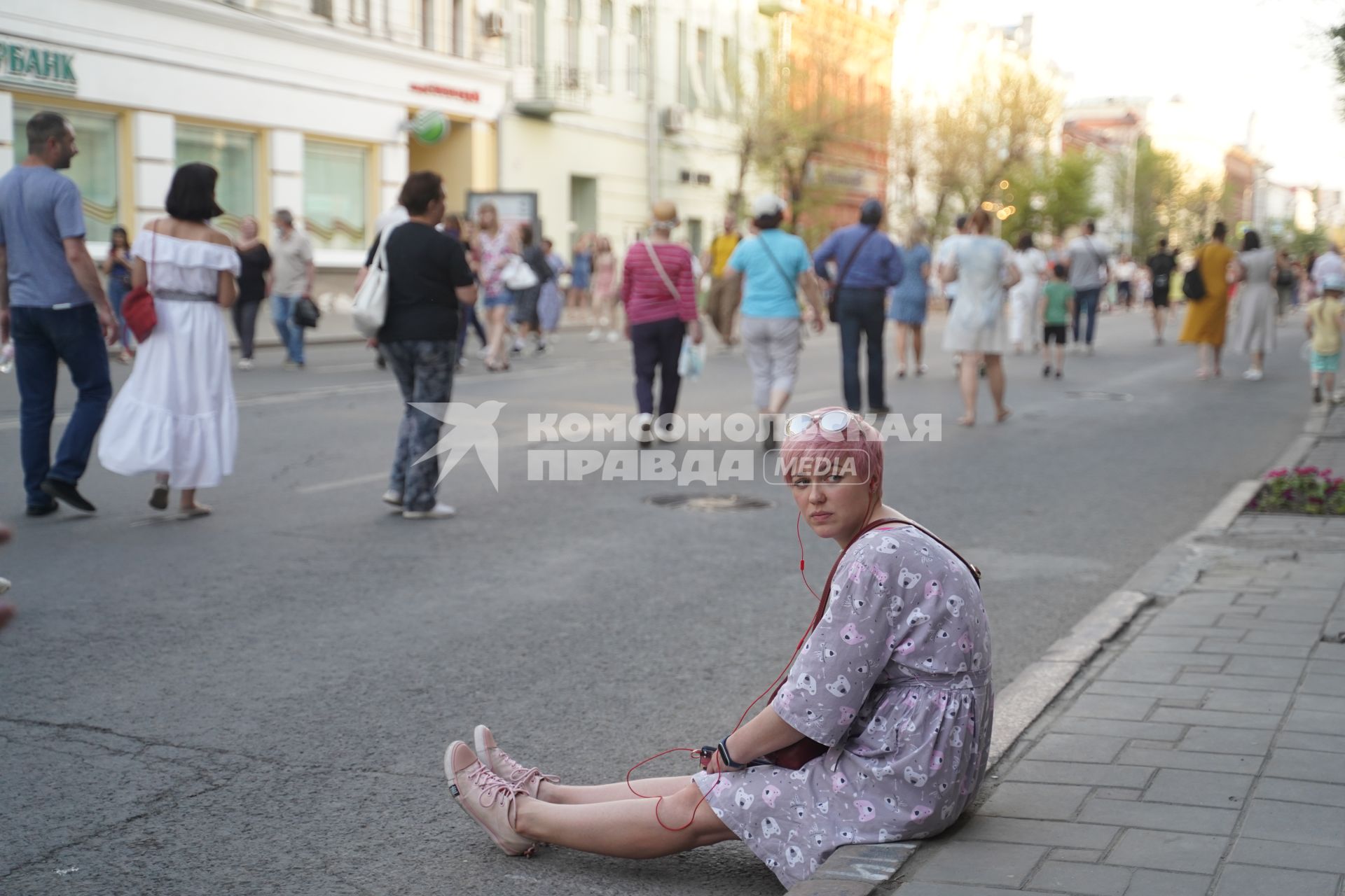 Самара. Девушка сидит на бордюре.