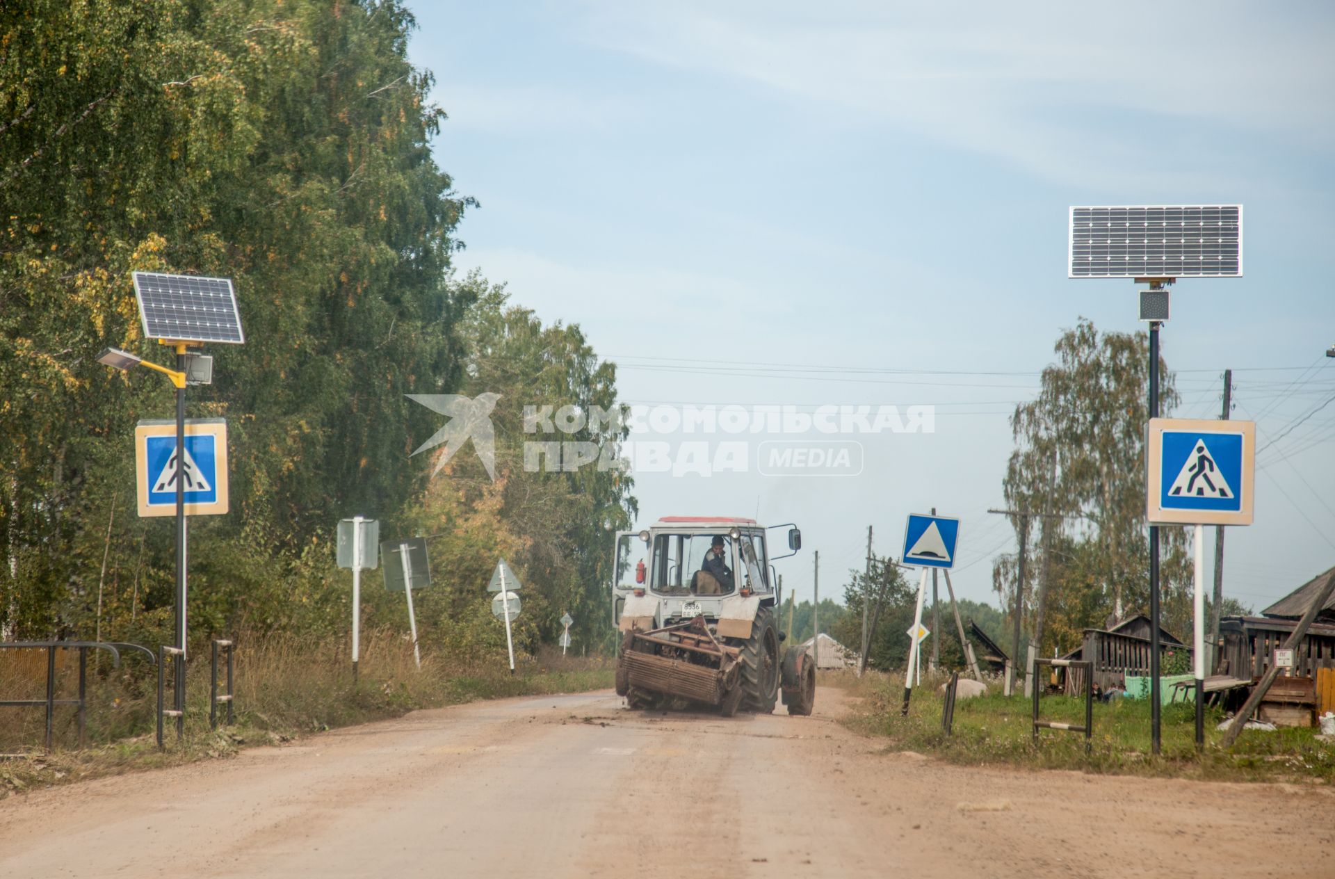 Пермский край. Трактор едет по проселочной дороге.