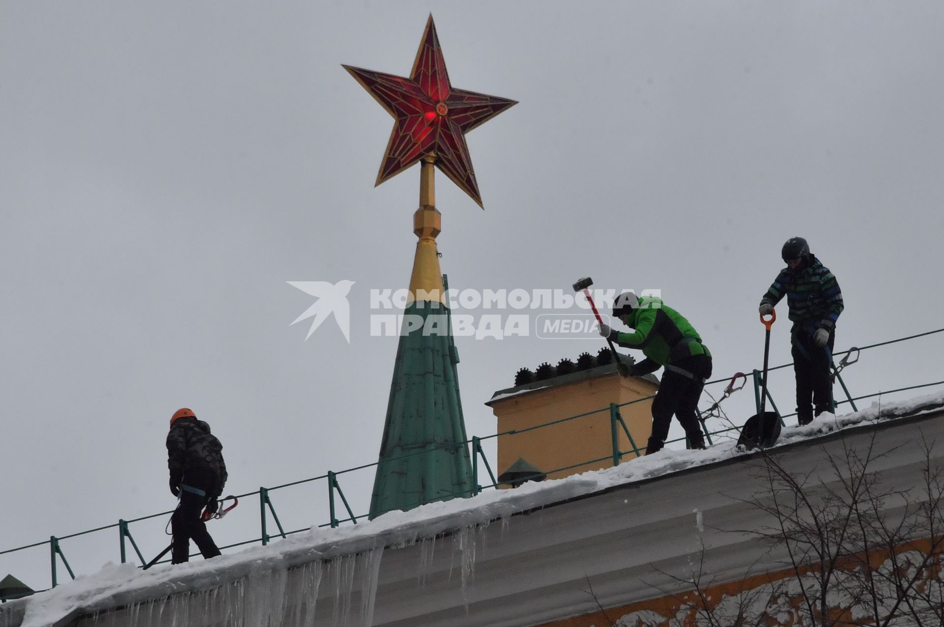 Москва. Сотрудники коммунальной службы чистят крышу здания Арсенала Московского Кремля от снега.