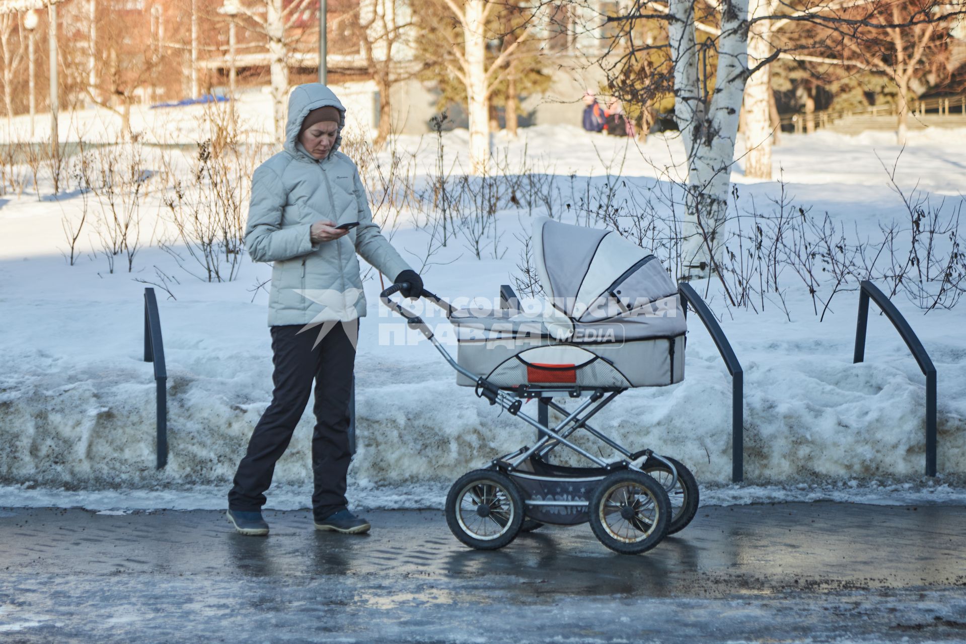 Пермь. Женщина гуляет с детской коляской.