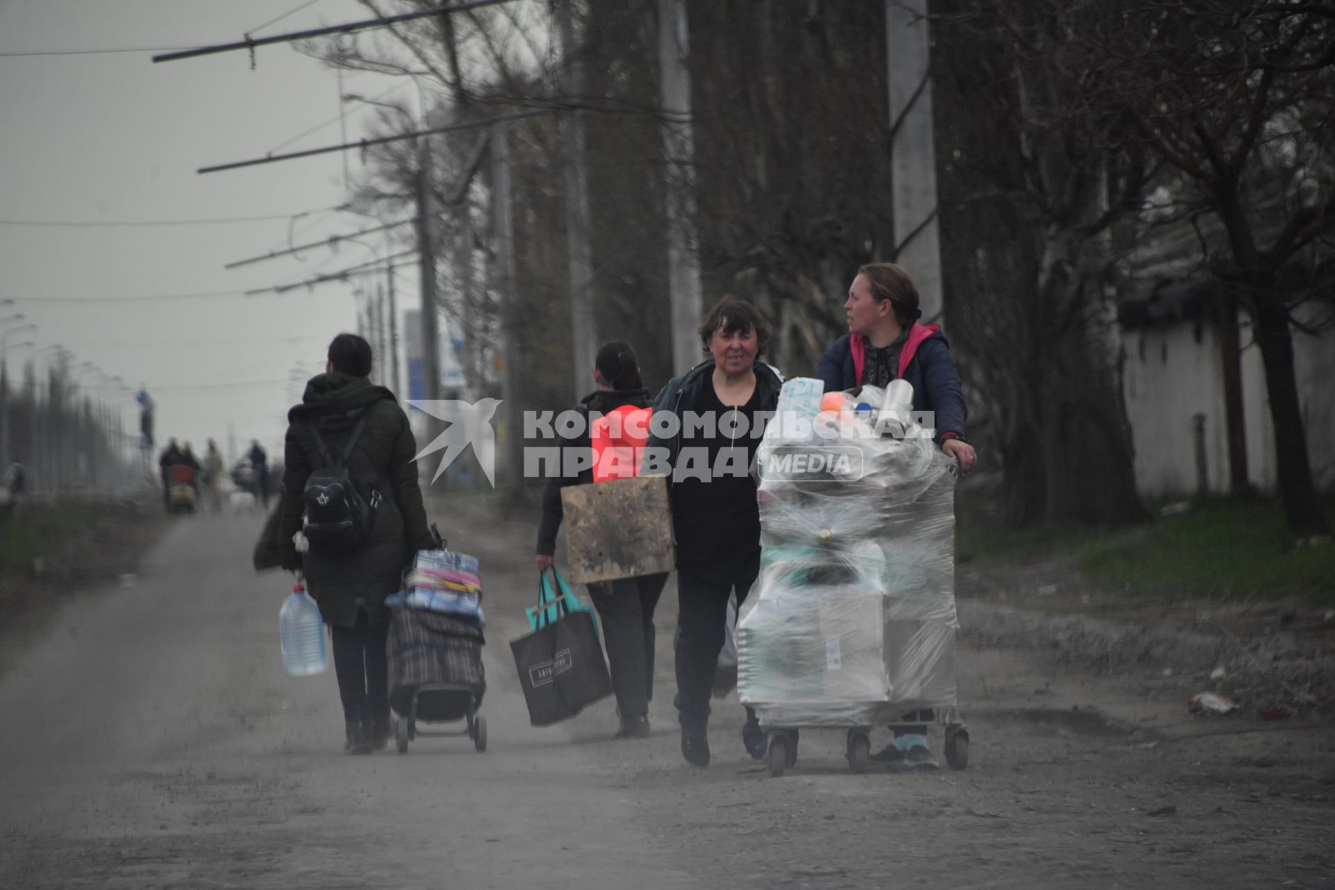 Донецкая область. г.Мариуполь. Жители города с вещами идут по улице.