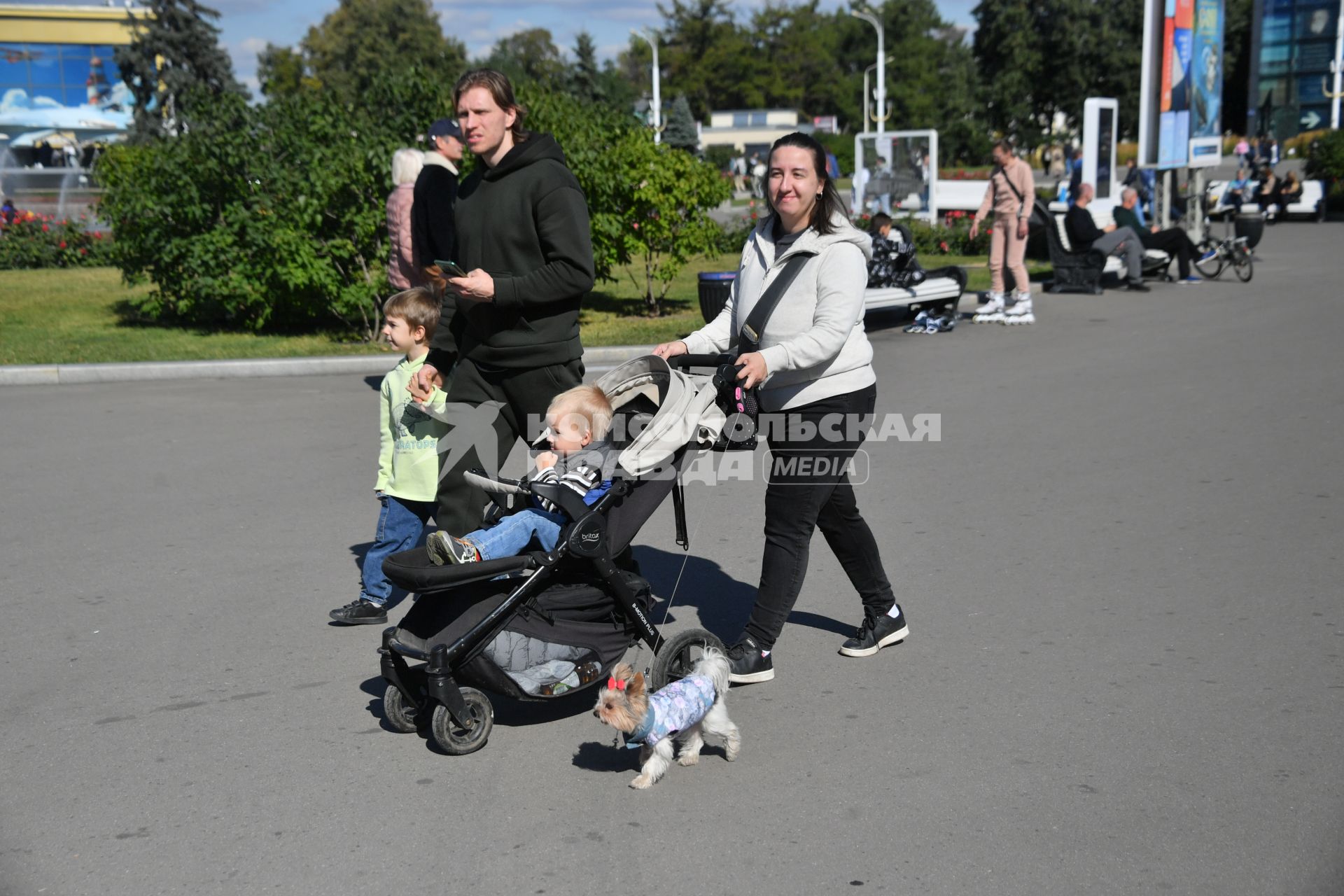 Москва. Женщина с ребенком в коляске и  маленькая собачка на ВДНХ.