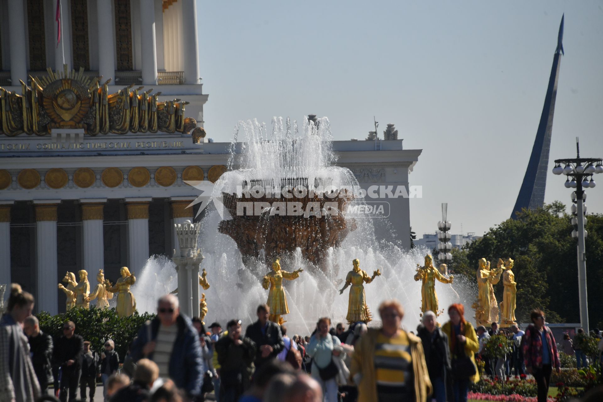 Москва.  Люди гуляют у фонтана   `Дружба народов` на ВДНХ во время празднования Дня города.