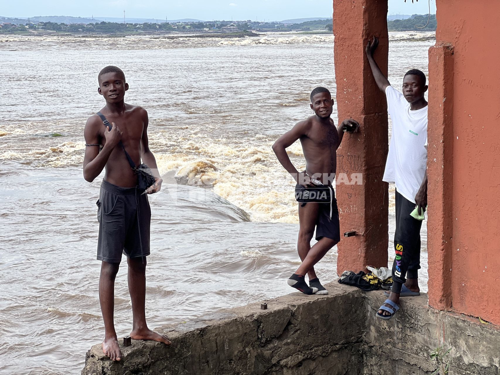 Республика Конго. г. Браззавиль. Конголезские парни развлекают туристов, прыгая с берега в бушующие воды реки Конго, а выбравшись обратно, требуют оплаты за шоу.