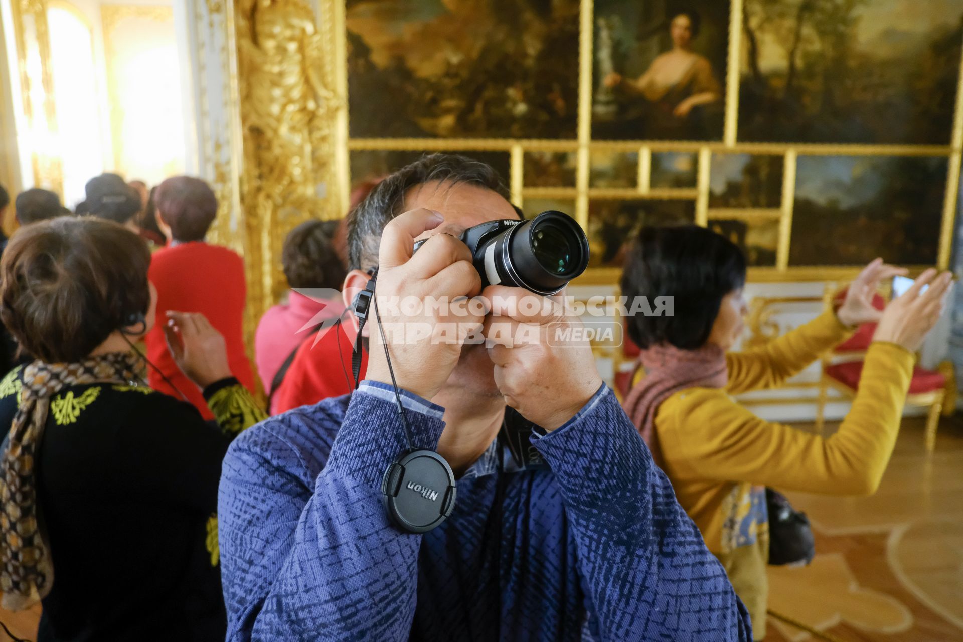 Санкт-Петербург.  Туристы из Китая фотографируют в  музее.