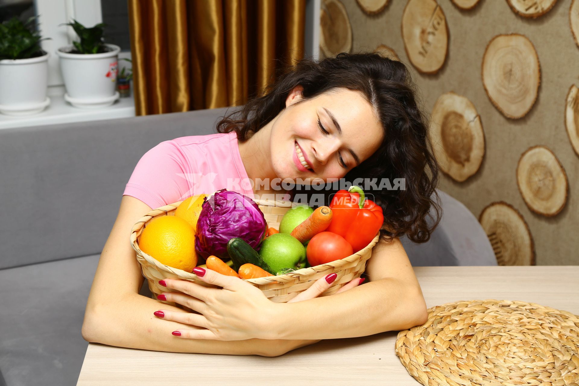 Москва. Девушка обнимает корзинку с овощами и фруктами.